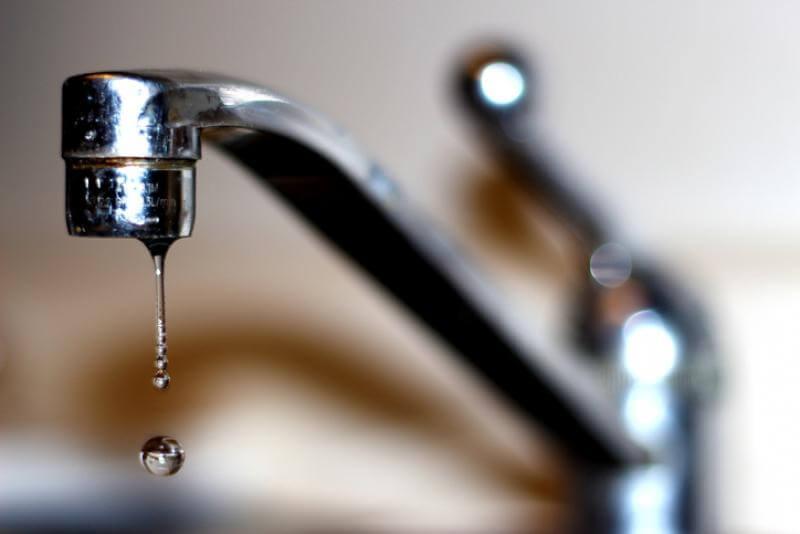 Close-up of a dripping household tap representing general plumbing repairs
